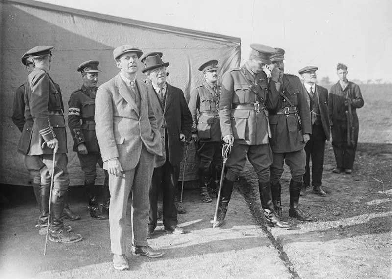 Herbert Asquith watches a squadron of aeroplanes returning to RFC Headquarters at Frevillers, 7 August 1916. Imperial War Museum.