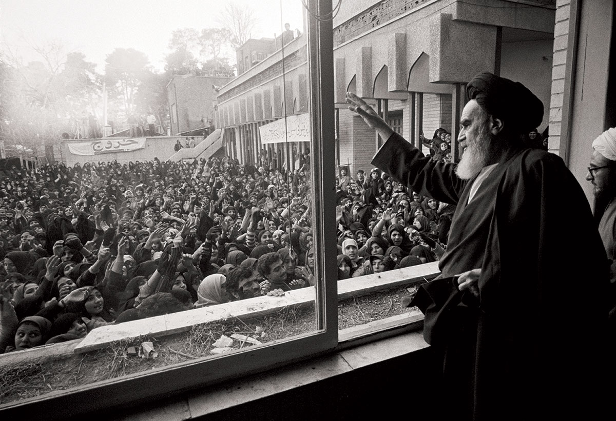 Ayatollah Khomeini greets the crowd at Tehran University after his return from exile in 1979.