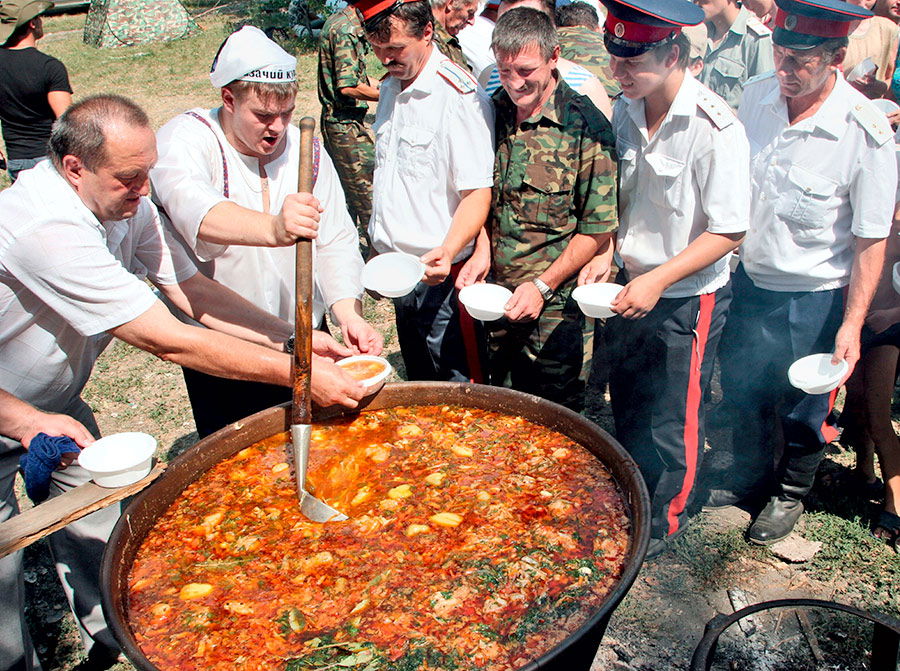 Don Cossacks in army uniform wait in line for borscht, 2006.