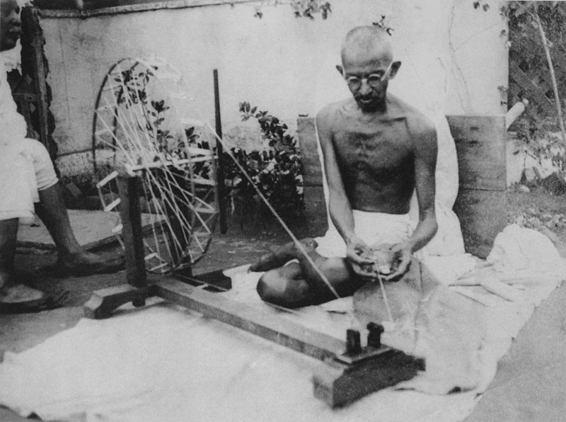 Mahatma Gandhi spinning yarn, in the late 1920s