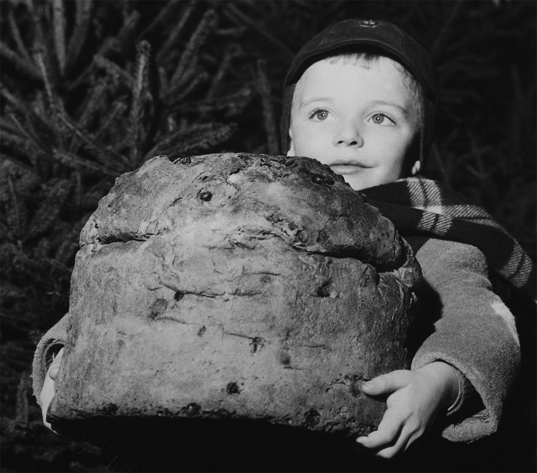 A child carrying a panettone in Milan, 20 December 1958.