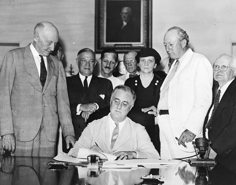 Roosevelt signs the Social Security Act, August 14, 1935