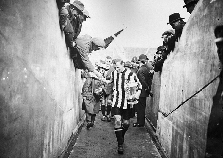 Frank Hudspeth carries the FA Cup after Newcastle United's win against Aston Villa in 1924. Topical Press Agency / Getty Images