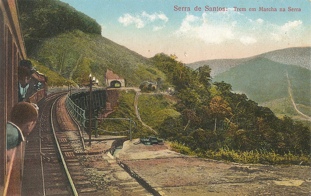 A hand-coloured postcard of an SPR train descending to the mouth of a tunnel.