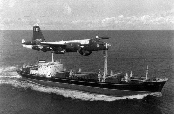 A US Navy P-2H Neptune of VP-18 flying over a Soviet cargo ship with crated Il-28s