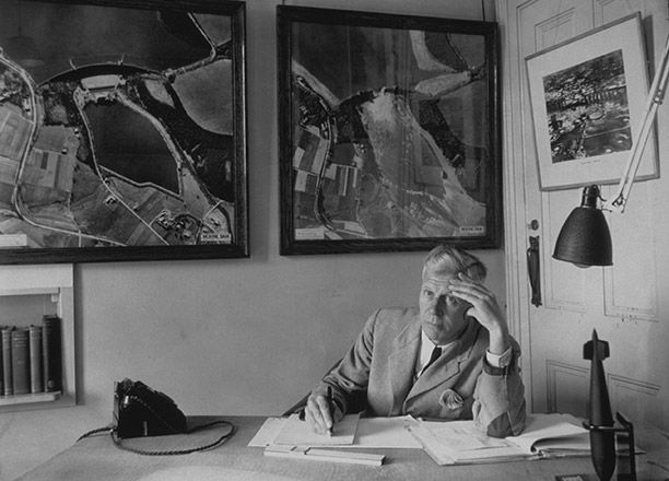 Barnes Wallis, c. 1945. On the wall are before and after pictures of the Möhne Dam. Getty/Hulton