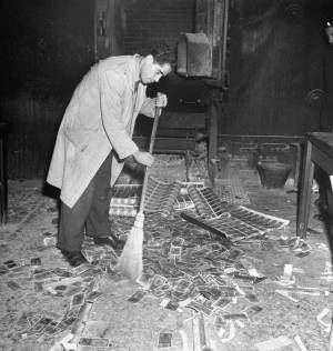 Sweeping old drachmas into a furnace, Athens, November 1944 (Getty Images / Time Life / Dimitri Kessel)