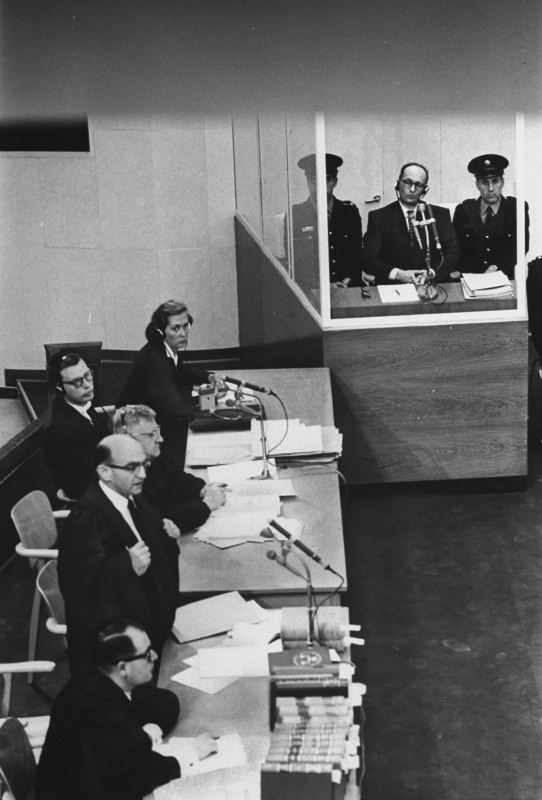 Adolf Eichmann sits in a glass booth as chief-prosecutor Gideon Hausner addresses the court in Jerusalem. Getty Images/Time Life