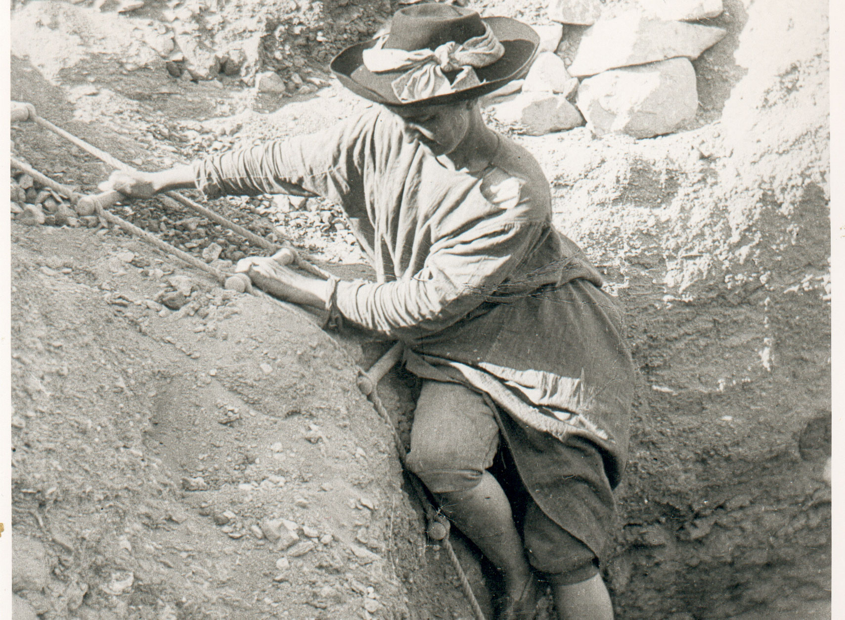 Image of Hilda Petrie climbs into a tomb, possibly Dendera, Egypt, 1897-8.  Courtesy of Egypt Exploration Society