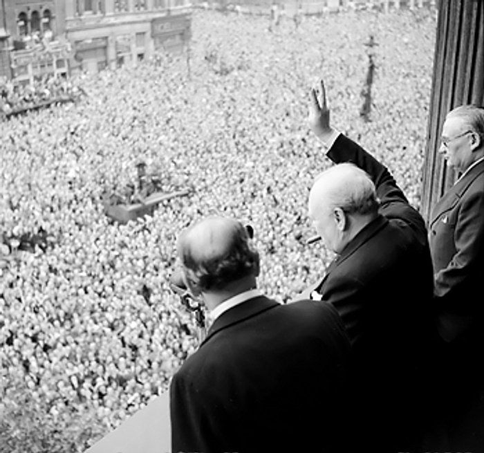 Winston Churchill waves to crowds in Whitehall, May 8th, 1945.