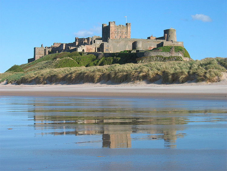 Bamburgh castle at the coast of Northumberland."Bamburgh 2006 closeup" by Michael Hanselmann - Quaoar10. Licensed under CC BY-SA 3.0 via Wikimedia Commons.