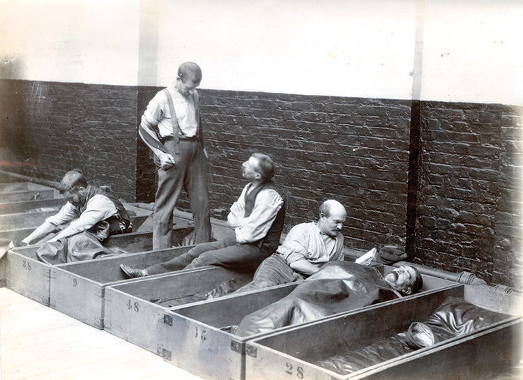 Men in 'coffin beds'.