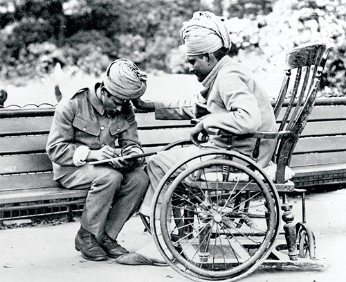 A wounded Indian soldier dictates his letter home to a scribe, Brighton,  c 1915.