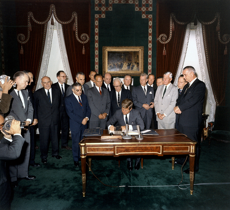 President Kennedy signs the Nuclear Test Ban Treaty, 7 October 1963.