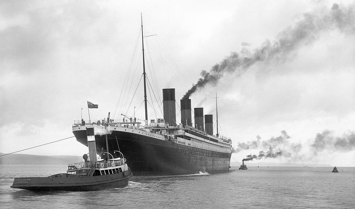 Titanic leaving Belfast with two guiding tugs visible