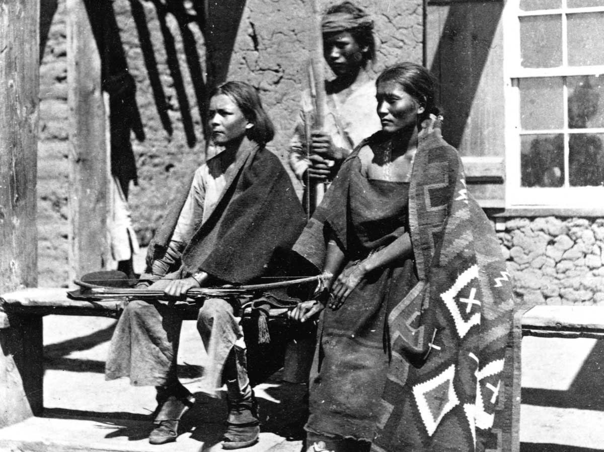 A Navajo woman and  two young men at Ford Defiance, in what was then New Mexico, 1873.