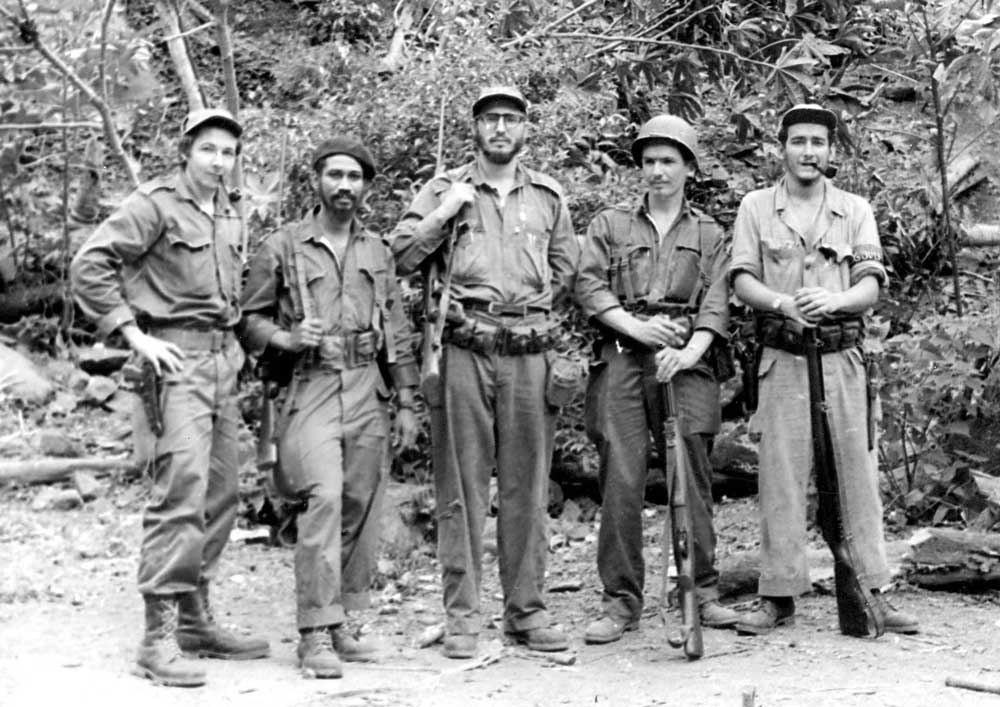 Fidel (centre)  and Raúl Castro (left  of centre) with rebel leaders in the mountains of Sierra Maestra, 1958.