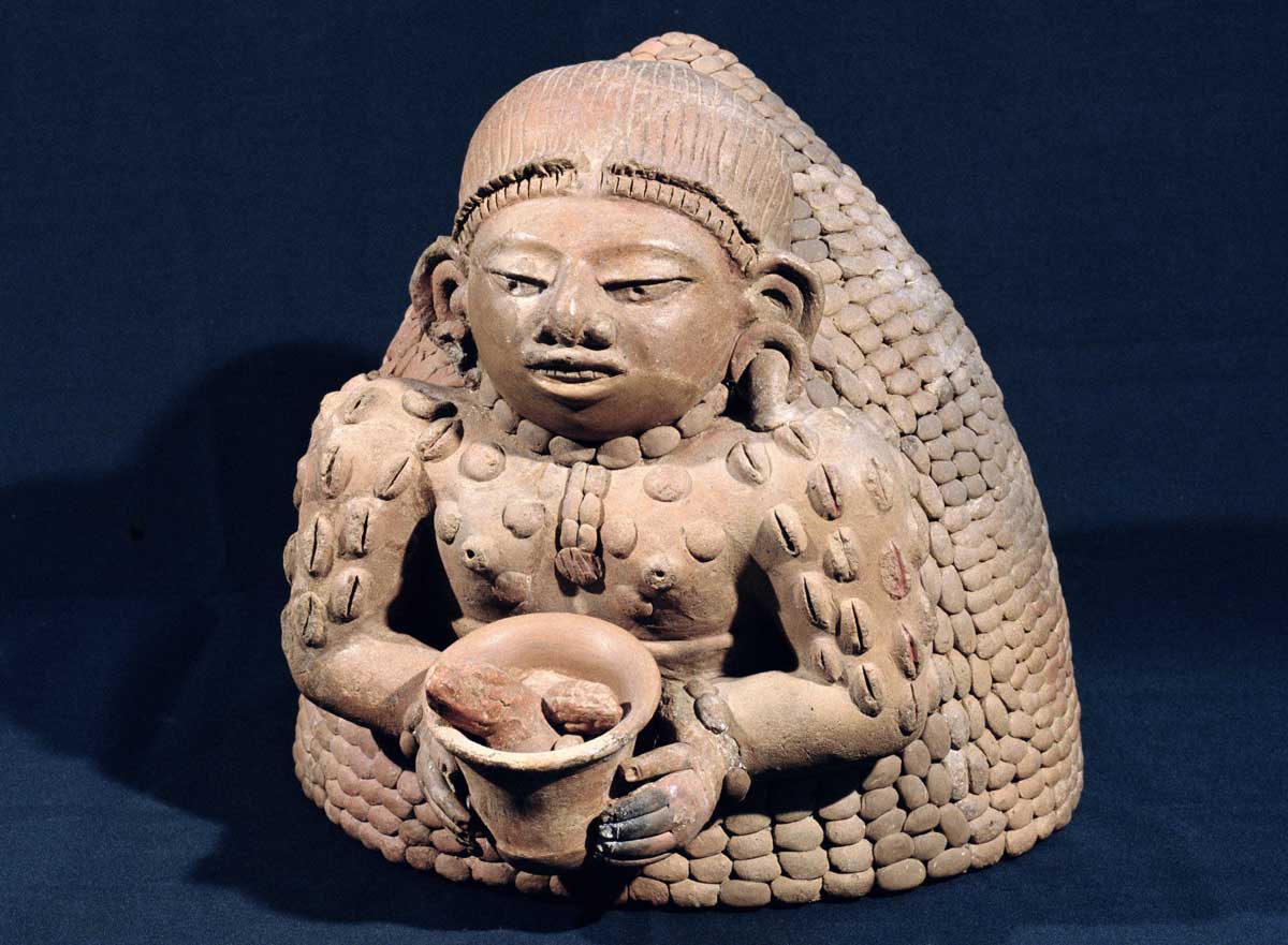 Woman holding cacao (and decorated with cacao beans), Maya, AD 250-450 © Bridgeman Images.