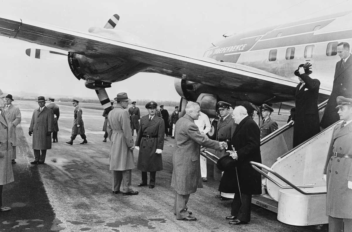 Photograph of President Truman greeting British Prime Minister Winston Churchill upon his arrival at Washington National Airport.