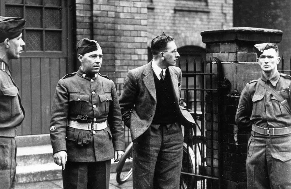 conscientious objector Sidney Spencer on his way to plead his case at Liverpool tribunal, 25 March 1941.