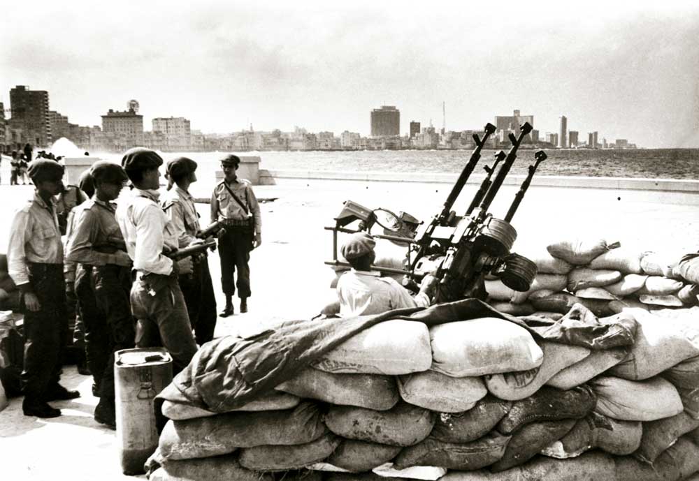 Cuban soldiers stand by an anti-aircraft gun, Havana, 1962.