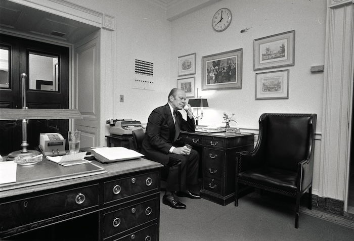 Gerald Ford taking a telephone call regarding the evacuation of Saigon, 29 April 1975. NARA. Public Domain.