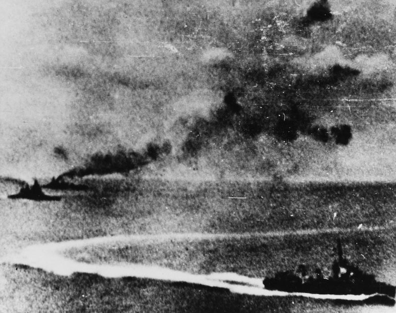 Photograph taken from a Japanese plane, with HMS Prince of Wales at far left and HMS Repulse immediately behind, 10 December 1941. US Naval History and Heritage Command. Public Domain.