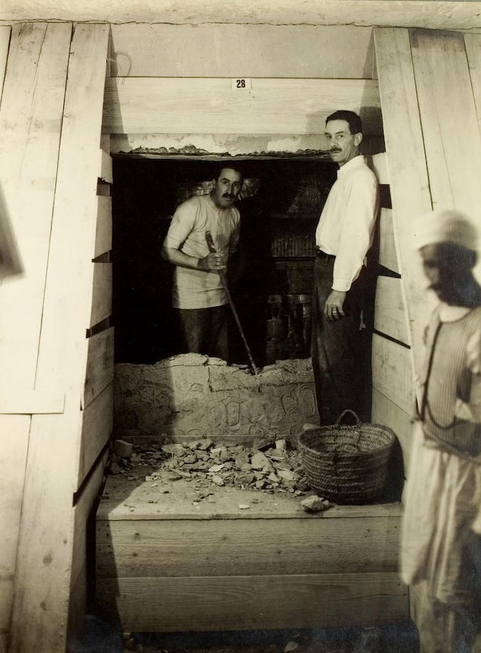 Howard Carter and Lord Carnarvon opening the wall to the burial chamber of the tomb of Tutankhamun, Harry Burton, 1923. Heidelberg University Library. Public Domain.