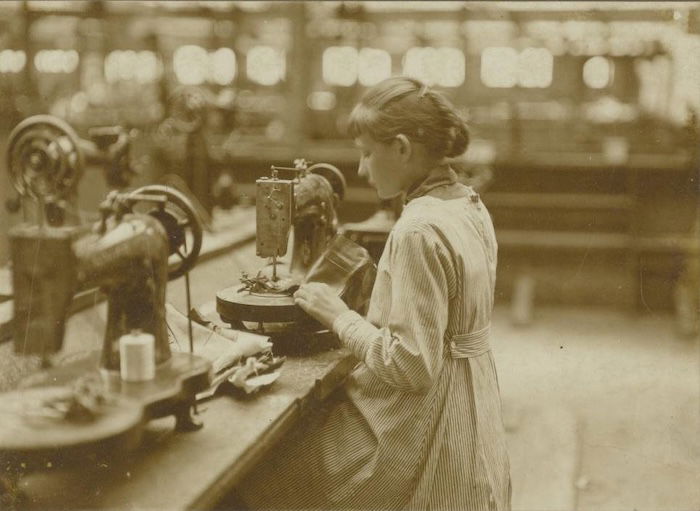 A girl at a sewing machine in a shoe factory, Tilburg, Netherlands, by Jan van Arendonk, 1928. Nationaal Archief. Public Domain.