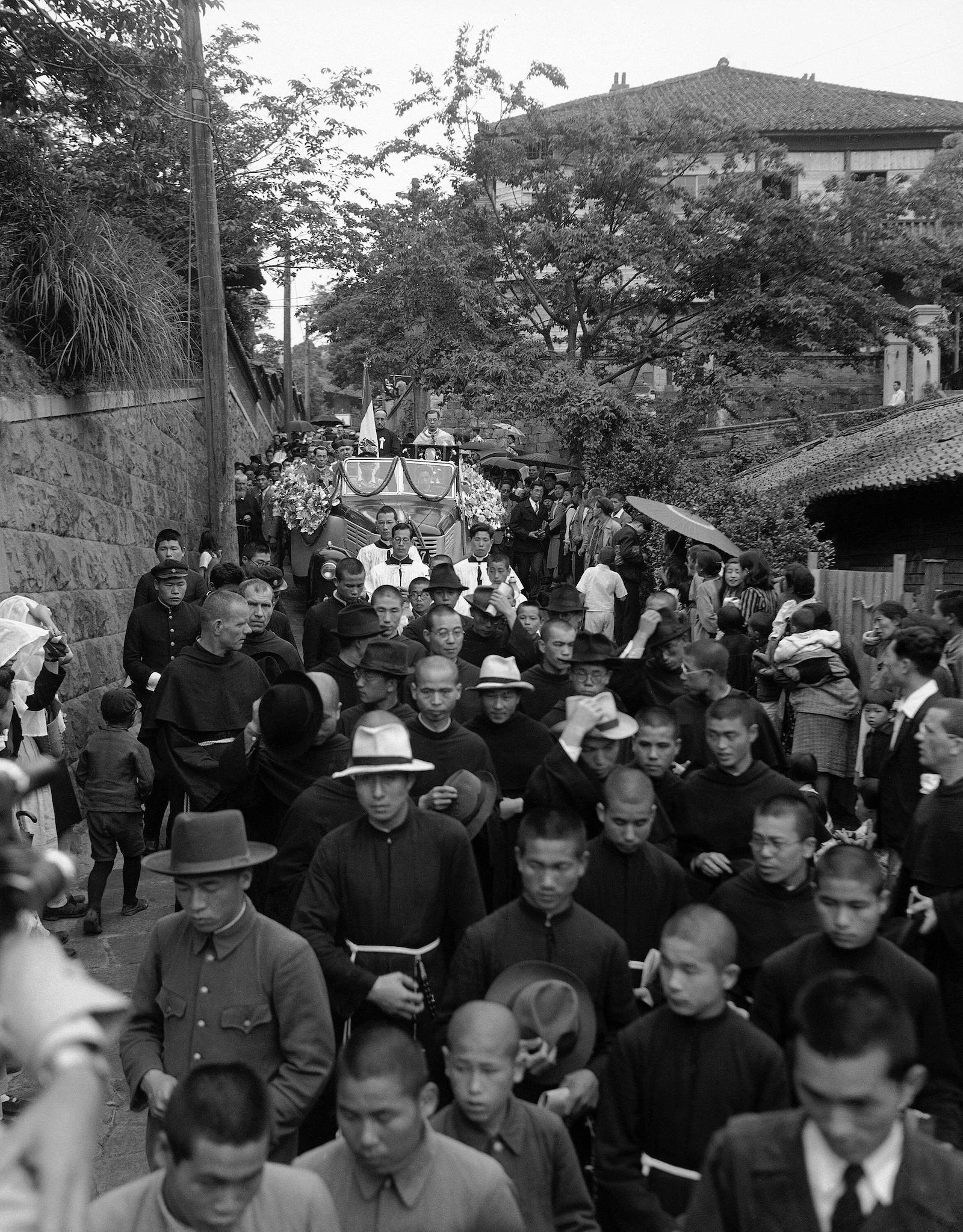 A procession carries the right arm of Francis Xavier through the streets of Nagasaki, 9 June 1949.