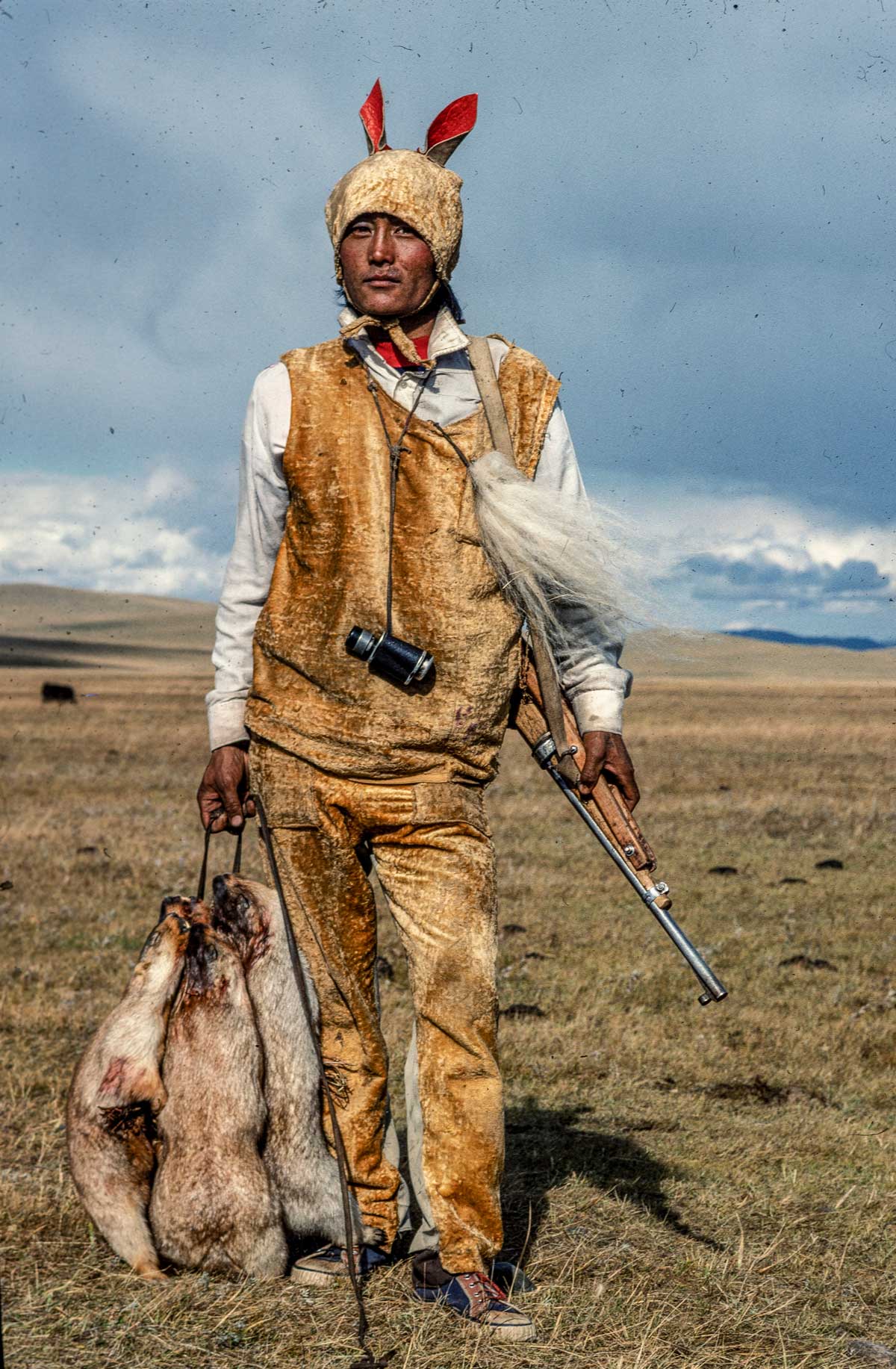 A Mongol marmot hunter disguised  as his prey, Mongolia, 1990.