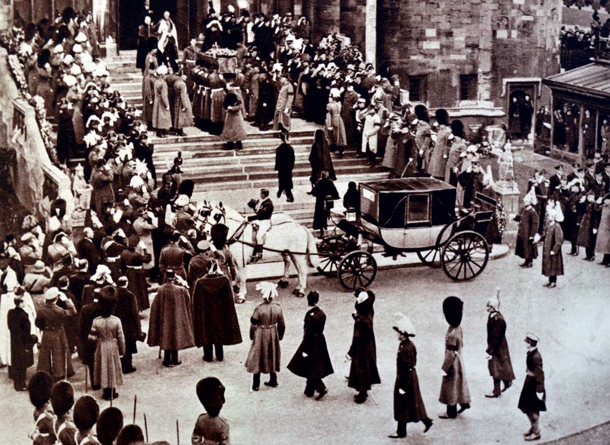 Guardsmen carry the coffin of George V up the steps of St George’s Chapel for the last rites, 29 January 1936. The future King Edward VIII can be seen with his mother walking behind the coffin. 