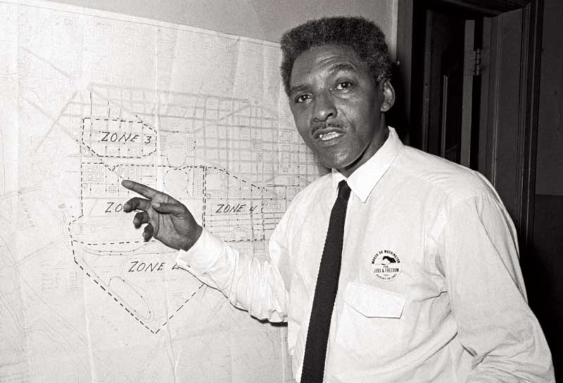Bayard Rustin with a map showing the route of the March on Washington, 13 August 1963. Bettman Archive via Getty Images.