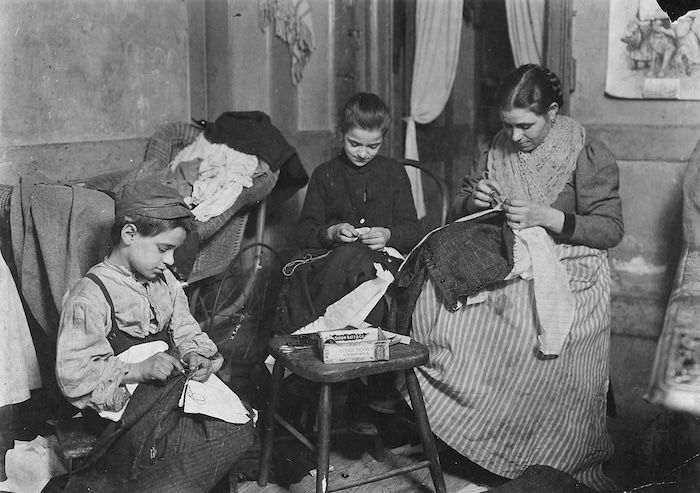 Garment workers at home, New York, by Lewis Hine, 1908. NARA. Public Domain.