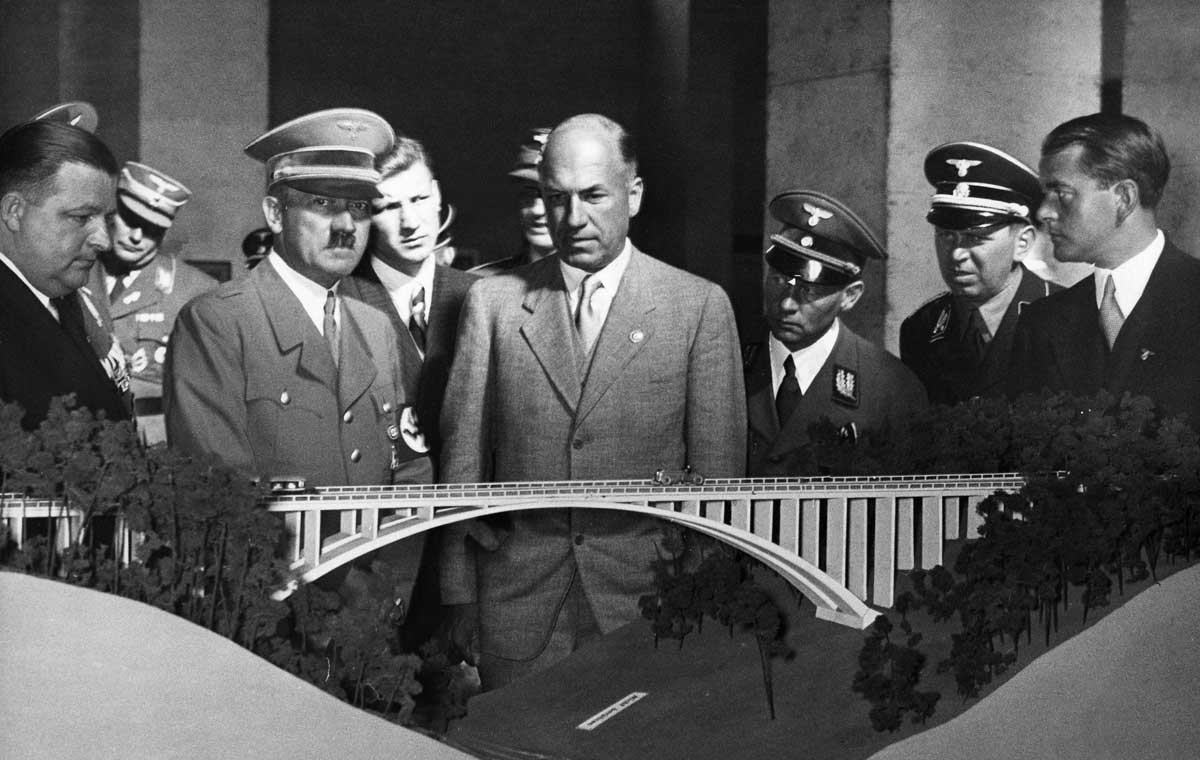 Hitler with Todt (centre) and Speer (far right) looking at the model of a motorway viaduct, 3 October 1937. Photograph by Heinrich Hoffmann © Ullstein Bild/Getty Images.