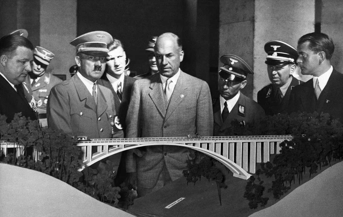 Hitler with Todt (centre) and Speer (far right) looking at the model of a motorway viaduct, 3 October 1937. Photograph by Heinrich Hoffmann © Ullstein Bild/Getty Images.