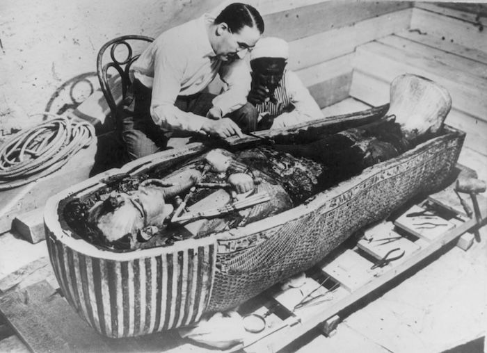 Howard Carter and an Egyptian colleague working on the third, solid-gold, coffin of Tutankhamun, photograph by Harry Burton, October 1925. Library of Congress. Public Domain.