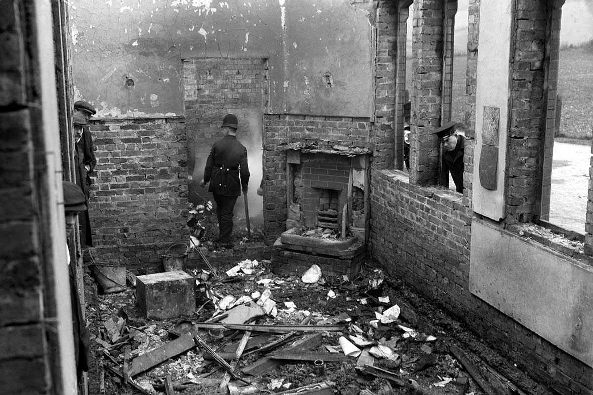 Police survey Saunderton Railway Station after a suffragette arson attack, March 9th, 1913. (Press Association Images)