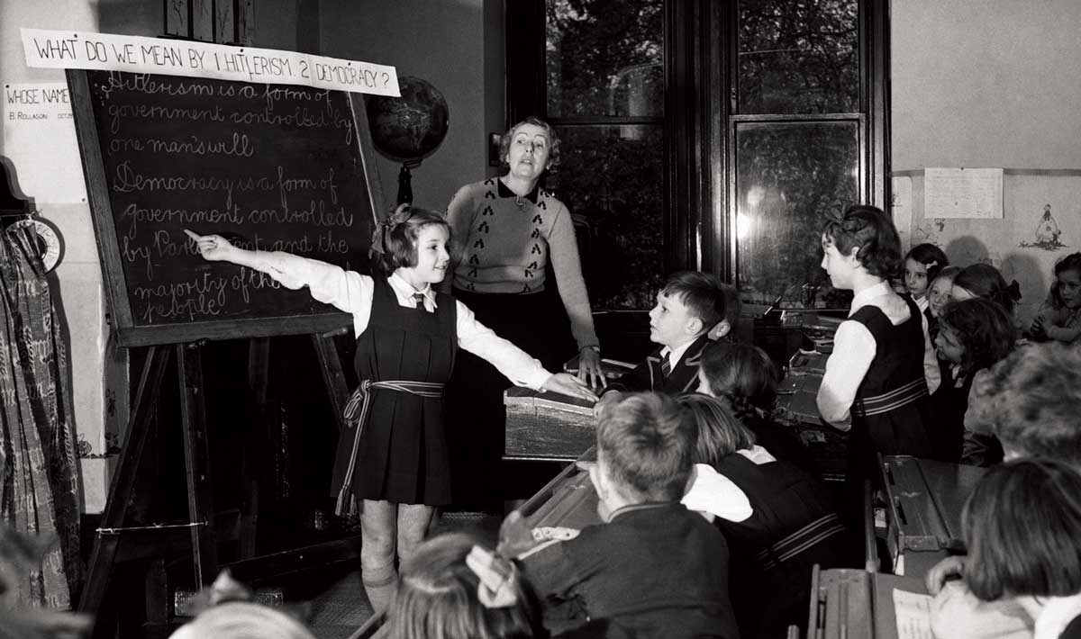 Children at Cheadle High School, Manchester, learning about ‘Hitlerism’ and ‘Democracy’, 1939 © Hulton Getty Images.