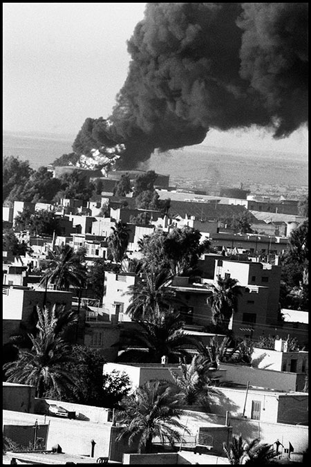 Baghdad burns: smoke from oil fires billows over the city following the coup.