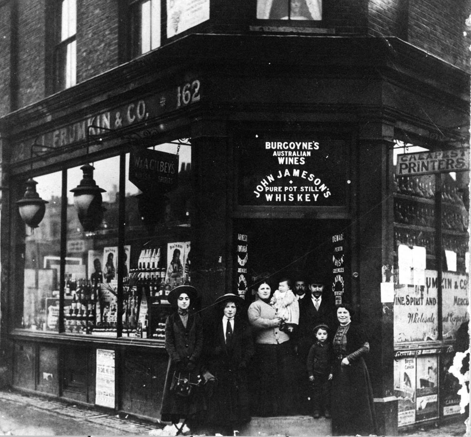 The Frumkin family standing outside their kosher wine and spirits shop on the corner of Commercial Road and Cannon Street Road, c.1912 (Jewish Museum London)