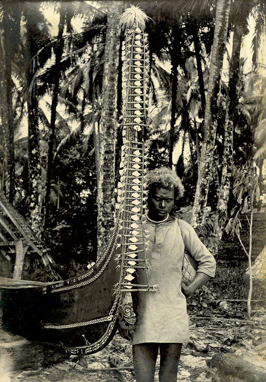 Man standing next to the prow of a canoe, New Georgia, Solomon Islands.