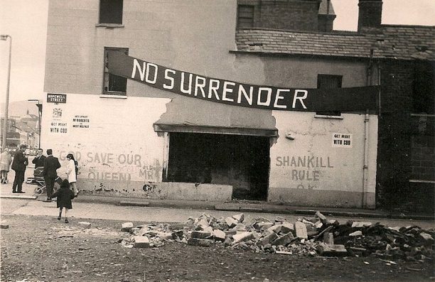 Loyalist banner and graffiti on a building in a side street off the Shankill Road, Belfast, 1970. Photo / 	Fribbler