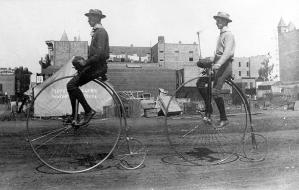 Two gentlemen ride penny-farthings in Los Angeles, 1886. 