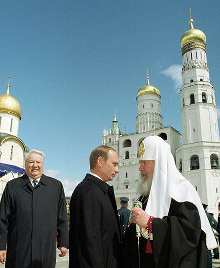 Vladimir Putin greets the Orthodox Church Patriarch Alexei II as Boris Yeltsin looks on, Moscow, May 2000. Wojtek Laski / Getty Images