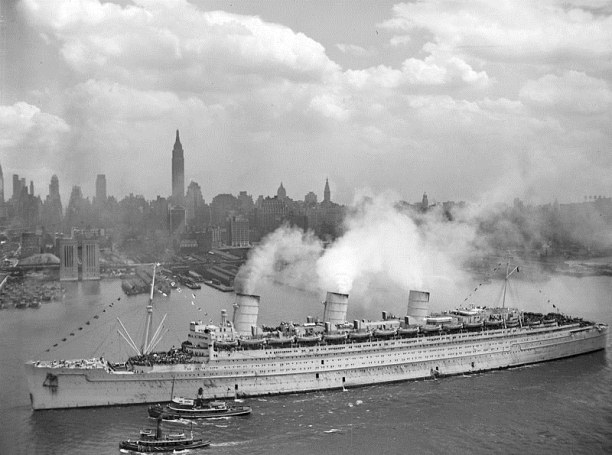 The British liner RMS Queen Mary arrives in New York harbour, 20 June 1945, with thousands of U.S. troops from Europe. The Queen Mary still wears her light grey war paint.
