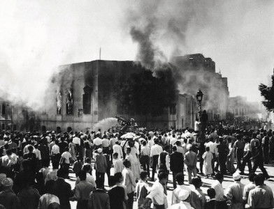 Crowds gather around the burning headquarters of the Muslim Brotherhood in Cairo, 27 October 1954.  It was set on fire after the attempted assassination of Gamal Abdel Nasser. Associated Press/Alamy.