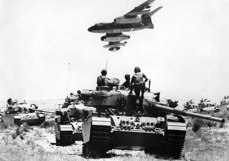 An Israeli Vautour  bomber flies over tanks assembling in the Negev desert on May 24th,  1967, two weeks before the outbreak of the  Six Day War.  © Topfoto