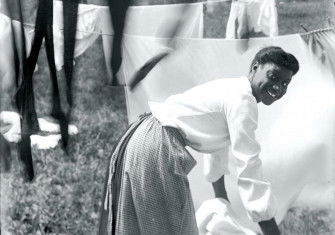 A young woman hanging up laundry, Newport, Rhode Island, 1903.