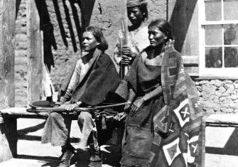 A Navajo woman and  two young men at Ford Defiance, in what was then New Mexico, 1873.